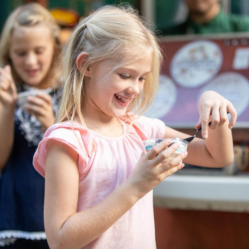 Girl eating from a snack cup